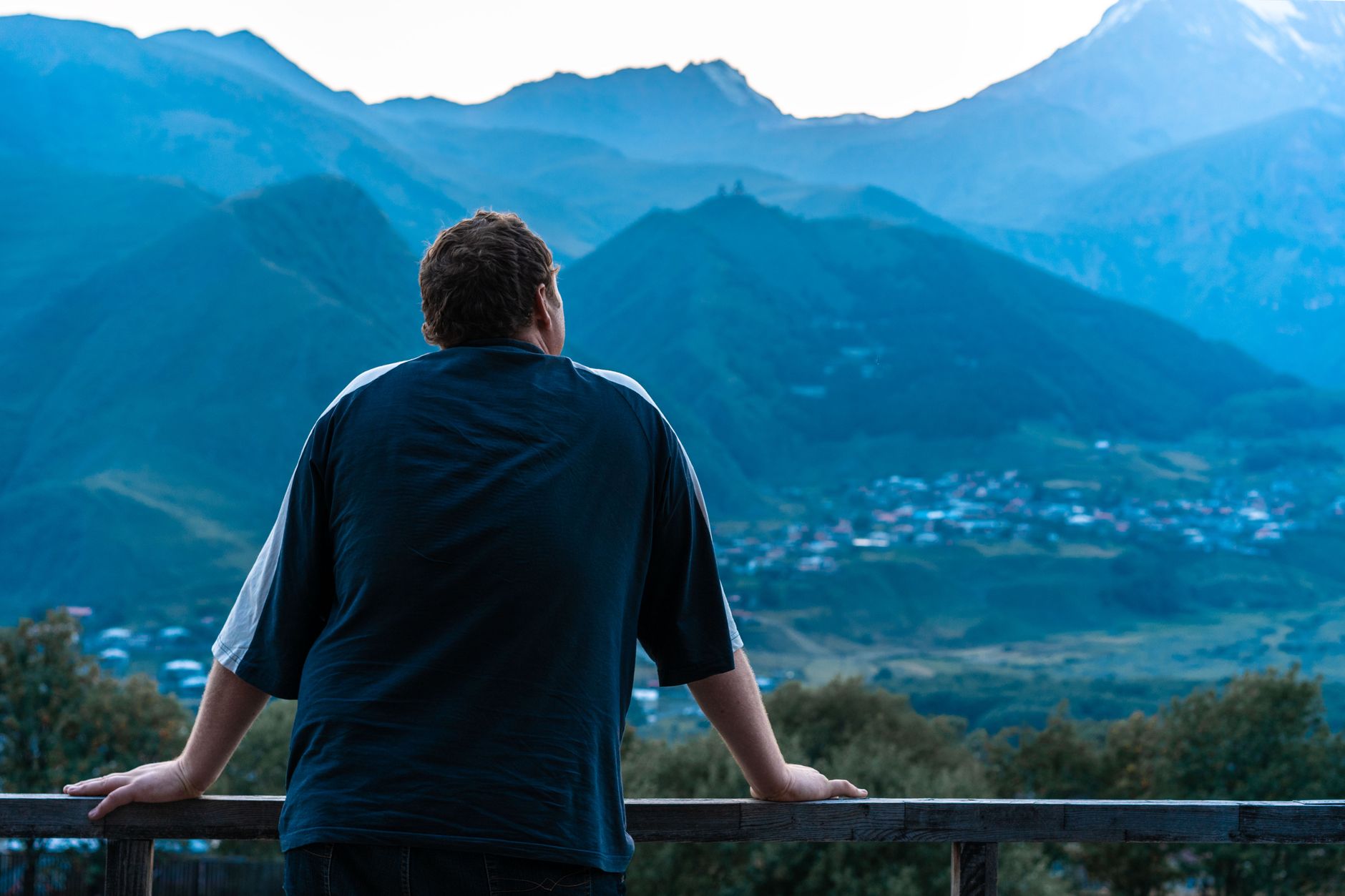 Travel photographer looking out over quiet misty landscape
